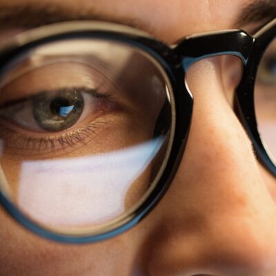 close up of woman eyes in glasses looking at computer screen