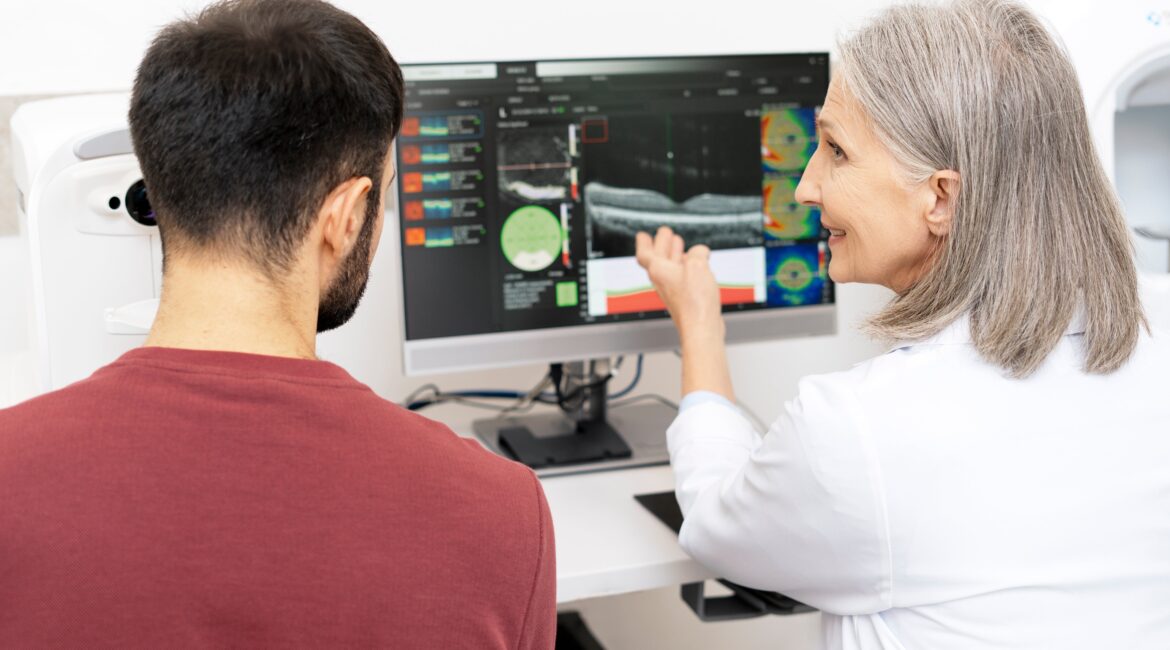 Ophthalmologist analyzing optical coherence tomography scan results on computer