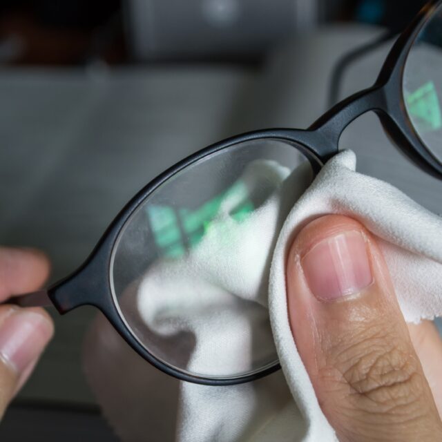 wiping glasses with microfiber cloth